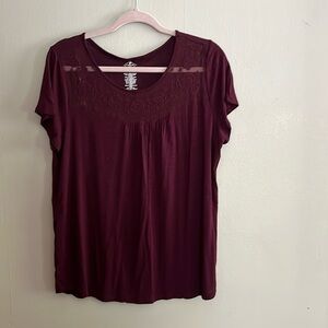 Burgundy color top with sheer lace embellishments at neckline